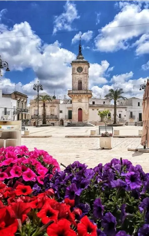 Ceglie Messapica main square with its clock tower and flowers